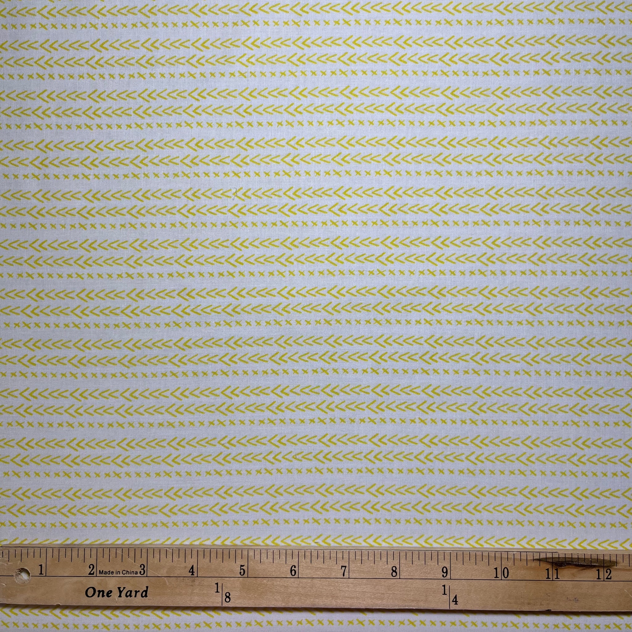Happy go Lucky is a great neutral fabric featuring tiny yellow checkmarks and x's on a white background. 