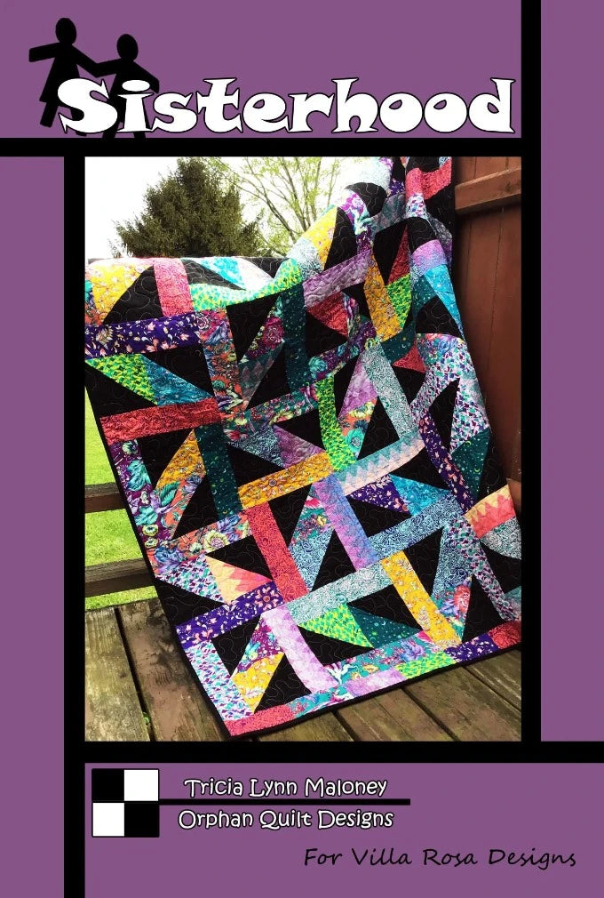 Sisterhood quilt pattern is a modern design using Fat Quarters and a solid black background, creating colorful grids.