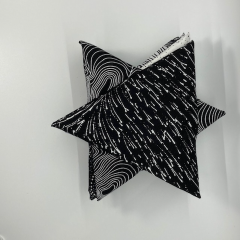 Australian Aboriginal Fabrics in black and white with a hint of grey, curated into a bundle of 10 Fat Quarters, folded into a Star Shape