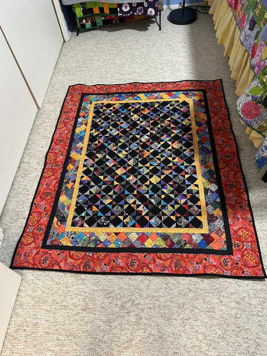 A colorful Scrap Quilt made from 600 Half Square triangles