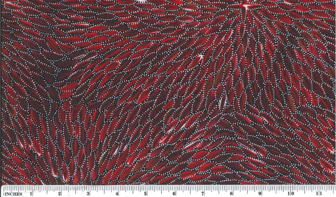  This 100% fine cotton fabric features delicate white dots arranged in leaf patterns against a rich red and burgundy background. 