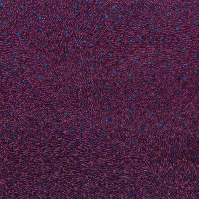 A close-up of a textured fabric with a dark purple base and a fine pattern of small blue and red dots.