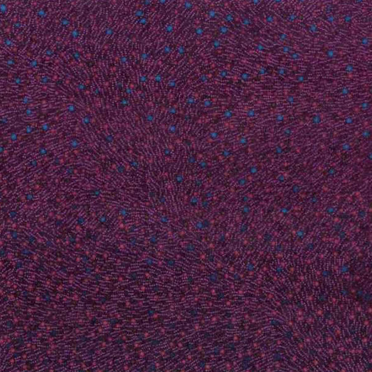 A close-up of a textured fabric with a dark purple base and a fine pattern of small blue and red dots.