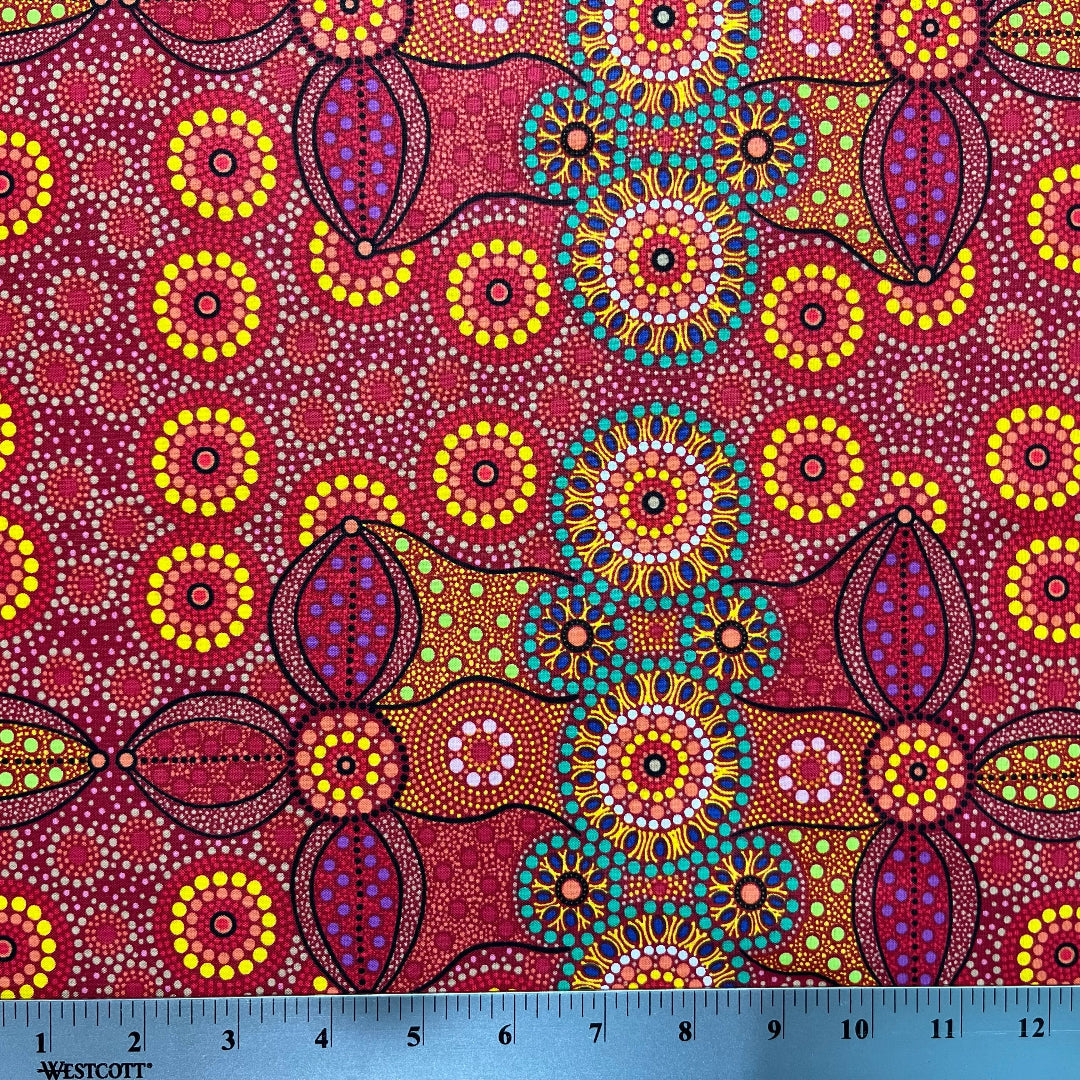 Campsite red is a striking design in vibrant shades of red, green and yellow with white circle accents by Aboriginal Artist Bernadine Wallace.