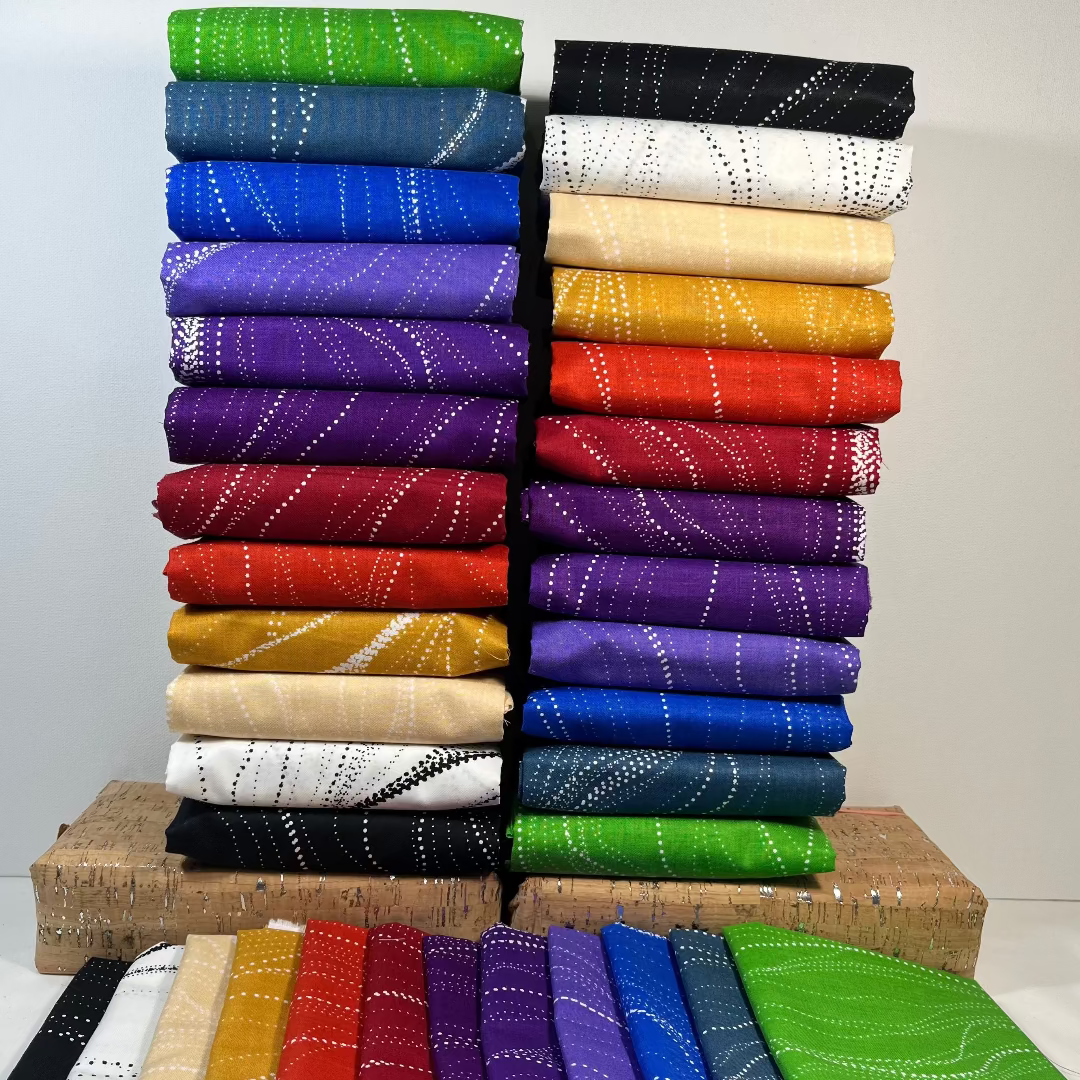 Sandhill Aboriginal design fabric in 12 different colors across the ainbow