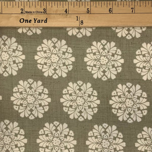 A stylized flower design in beiges and cream.