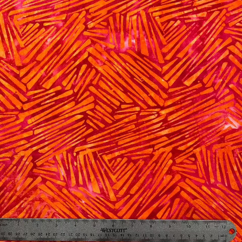 Talented Indonesian artists created this lively batik in sparkling orange triangles that tumble over a carmine background.