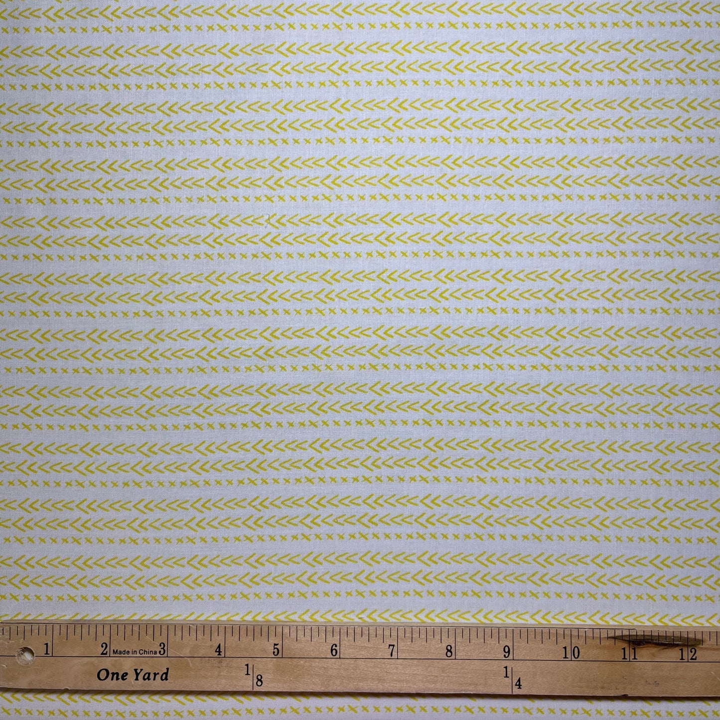 Happy go Lucky is a great neutral fabric featuring tiny yellow checkmarks and x's on a white background. 