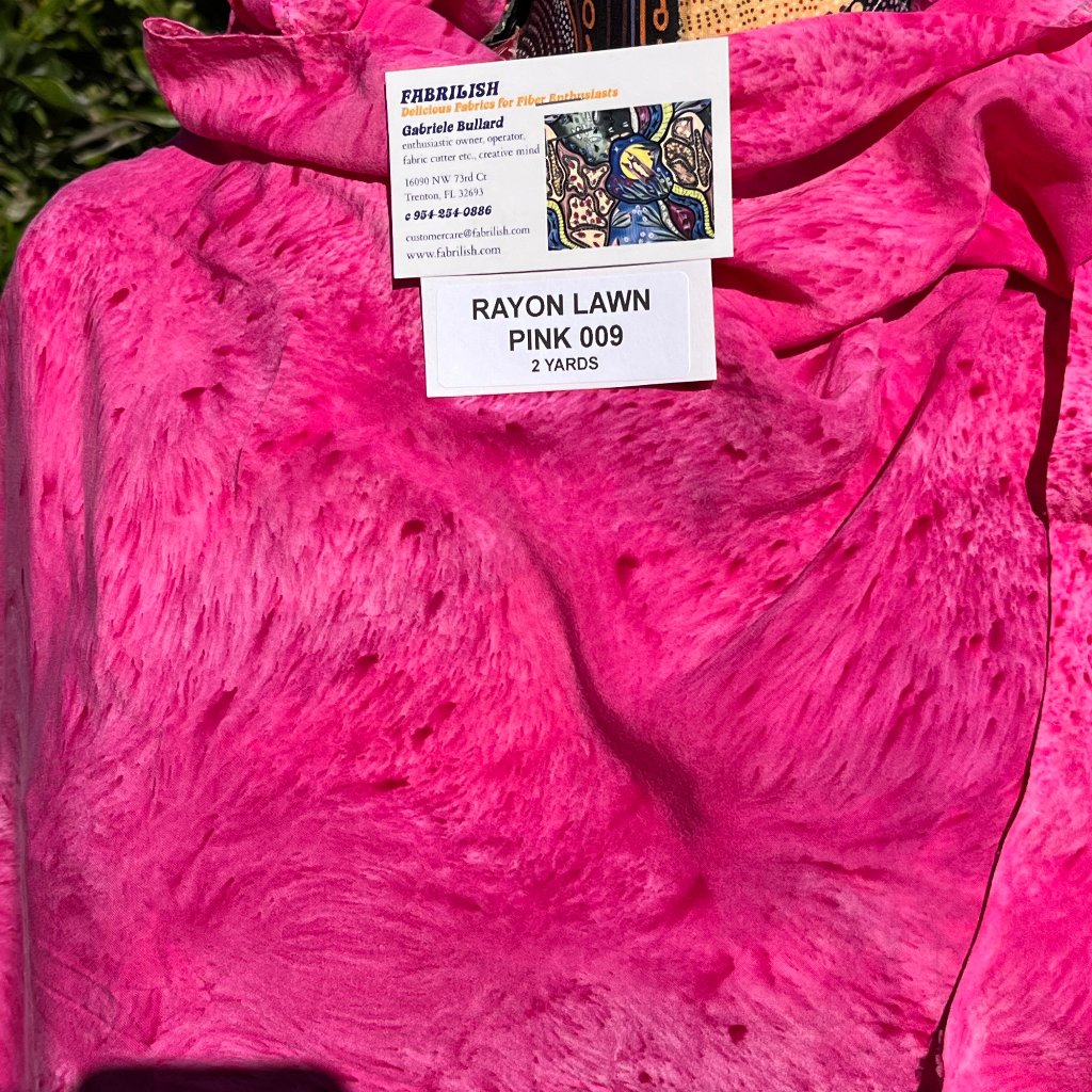 A SPLATTER DYED PINK PIECE OF FABRIC