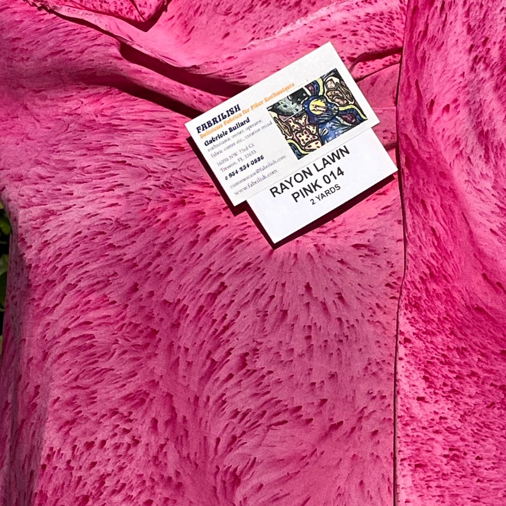 A SPLATTER DYED PINK PIECE OF FABRIC