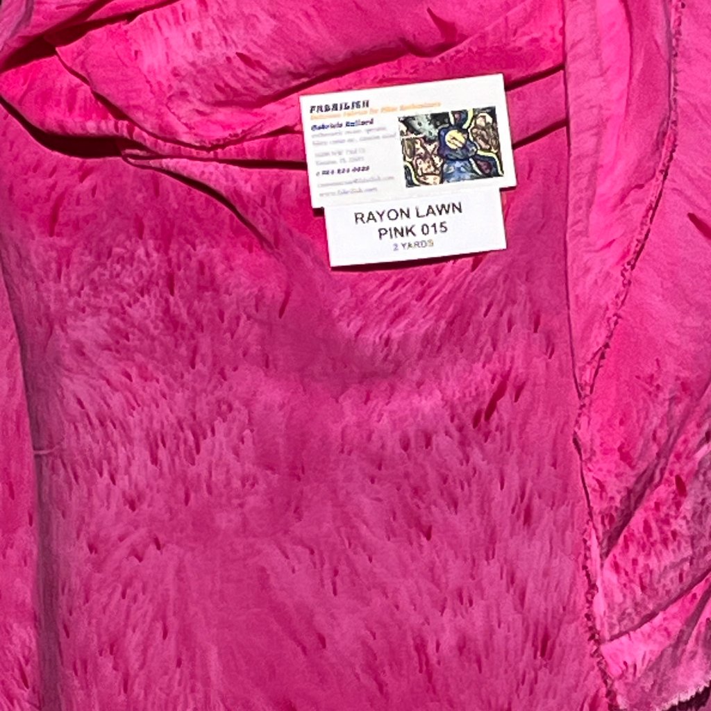 A SPLATTER DYED PINK PIECE OF FABRIC