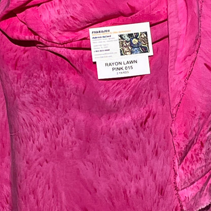 A SPLATTER DYED PINK PIECE OF FABRIC