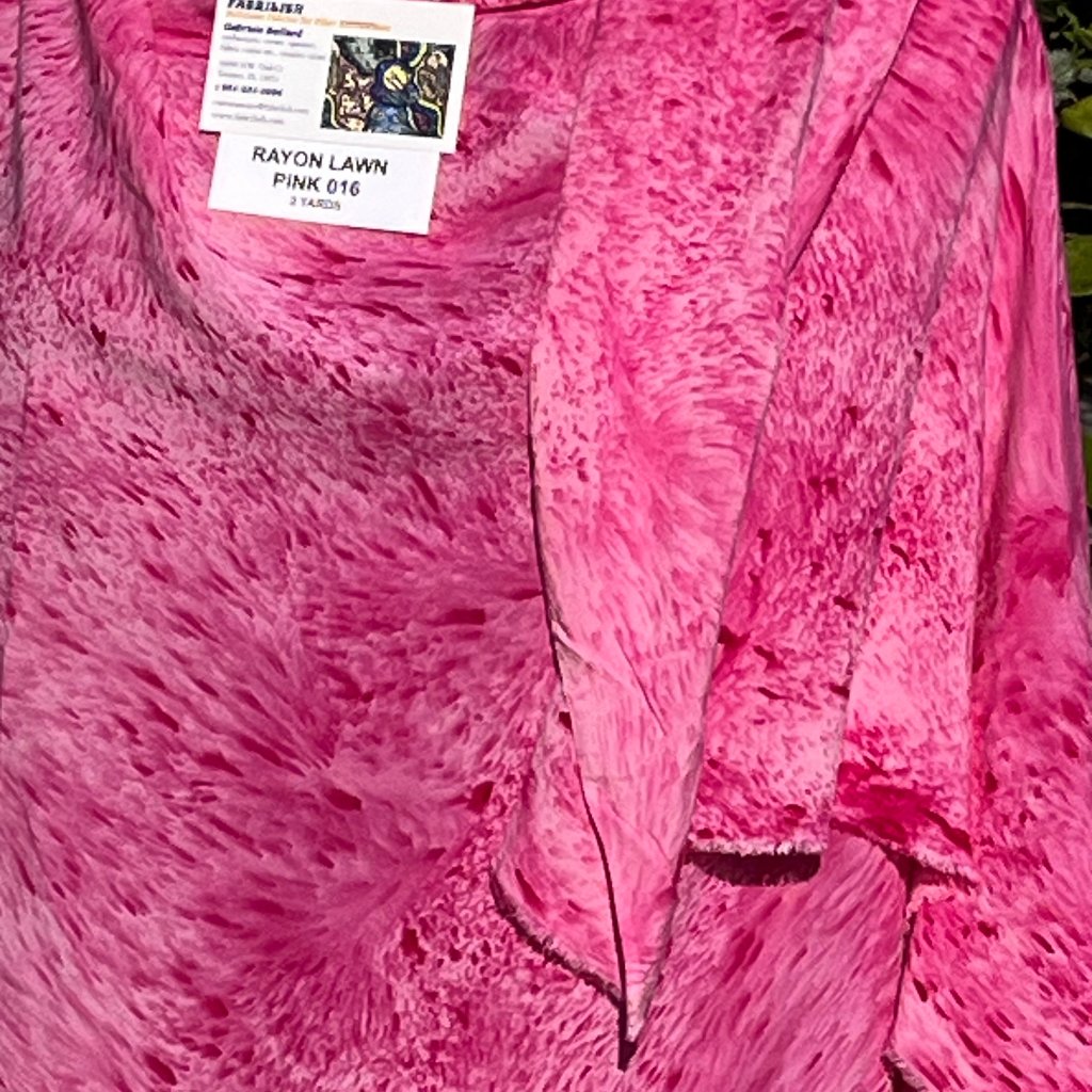 A SPLATTER DYED PINK PIECE OF FABRIC
