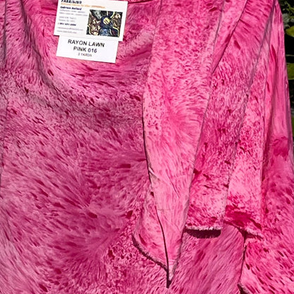 A SPLATTER DYED PINK PIECE OF FABRIC
