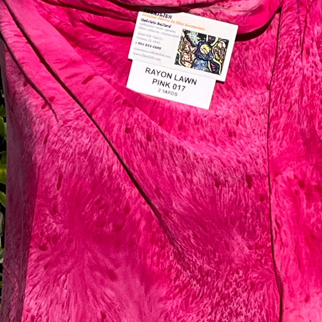 A SPLATTER DYED PINK PIECE OF FABRIC