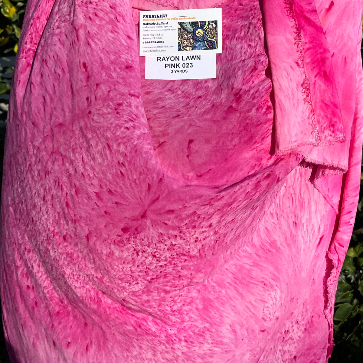 A SPLATTER DYED PINK PIECE OF FABRIC