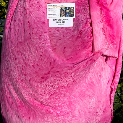 A SPLATTER DYED PINK PIECE OF FABRIC