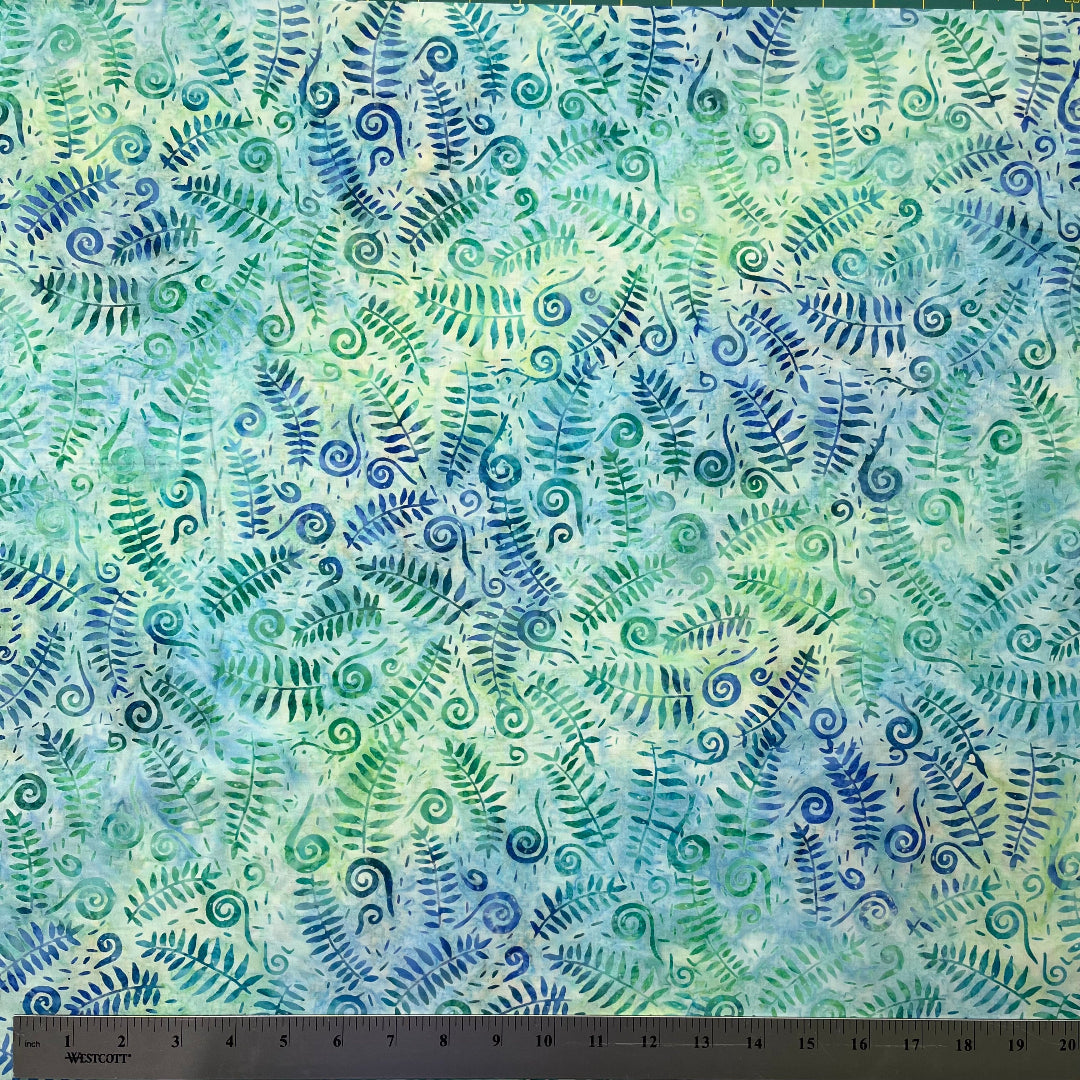 Fabric with blue and green fern leaf pattern and ruler at the bottom