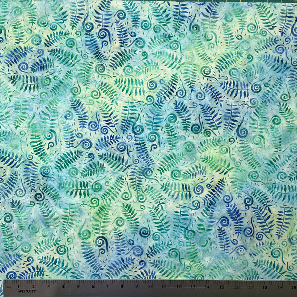 Fabric with blue and green fern leaf pattern and ruler at the bottom