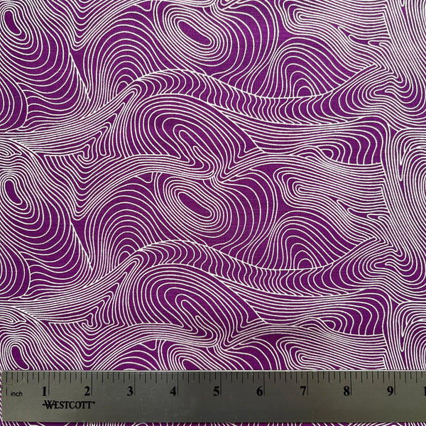 Fabric with purple and white wavy pattern, ruler at the bottom for scale.