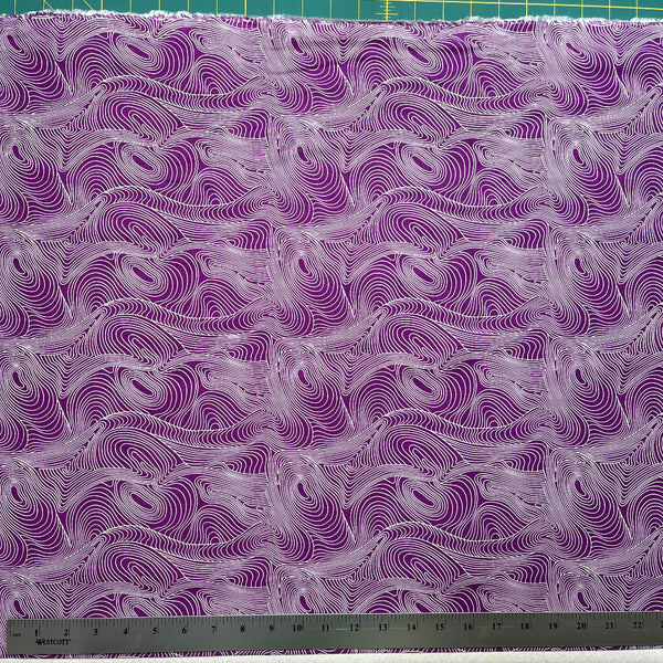 Purple and white wavy patterned fabric with a ruler at the bottom for scale.