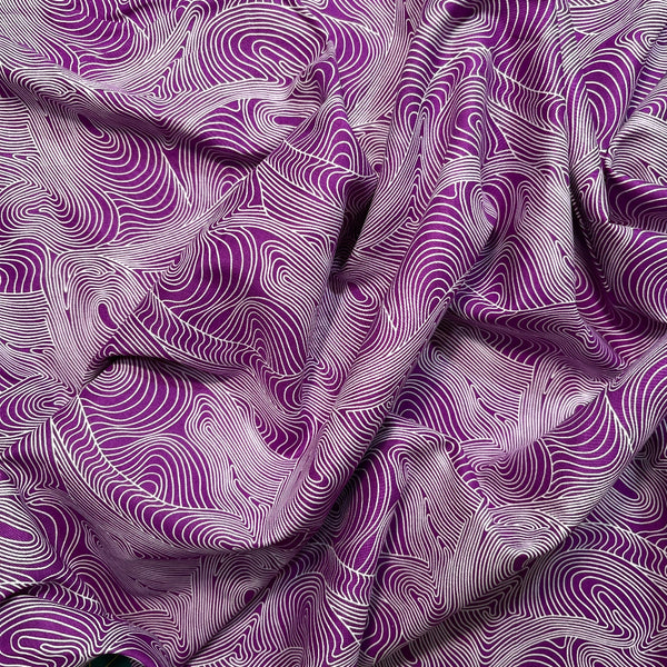 Purple fabric with wavy white pattern