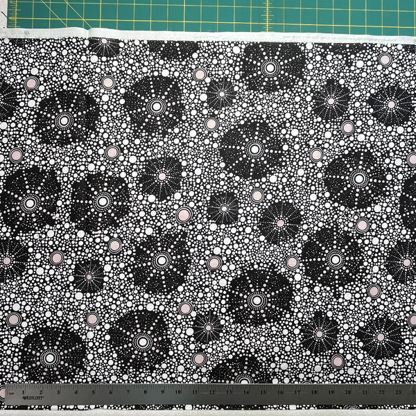 Black and white geometric pattern on fabric with a ruler at the bottom.