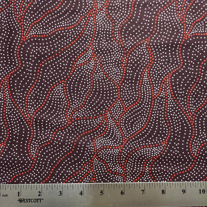 Fabric with red and white pattern and a ruler for scale