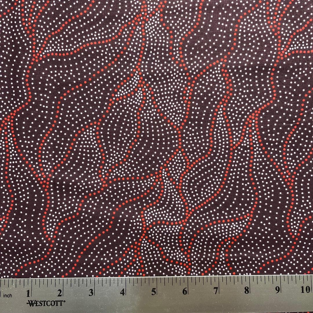 Fabric with red and white pattern and a ruler for scale