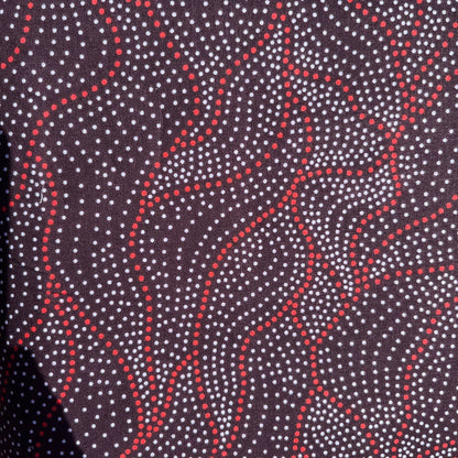 Close-up of fabric with red and white pattern on a dark background