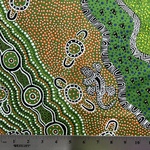  Aboriginal art pattern with a lizard design on fabric, featuring a ruler at the bottom for scale.