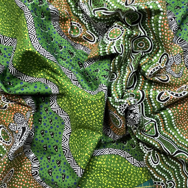 Heather's design portrays how the Goanna is hunting for its food in the Aboriginal Habitat, a green background with yellow and lime dots, and black and white decorations.
