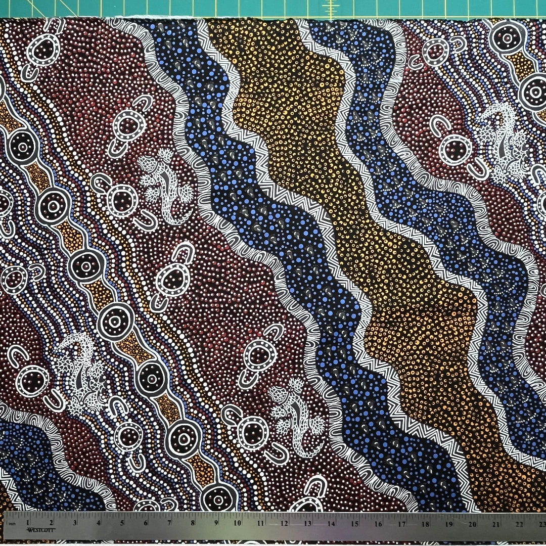Heather's design portrays how the Goanna is hunting for its food in the Aboriginal Habitat, a black background with yellow, brick red and blue dots, and black and white decorations.