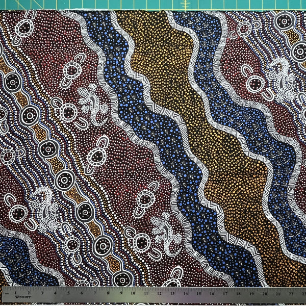 Heather's design portrays how the Goanna is hunting for its food in the Aboriginal Habitat, a black background with yellow, brick red and blue dots, and black and white decorations.