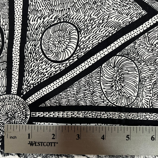 White and black fabric with abstract design, detail picture with ruler for sca;e