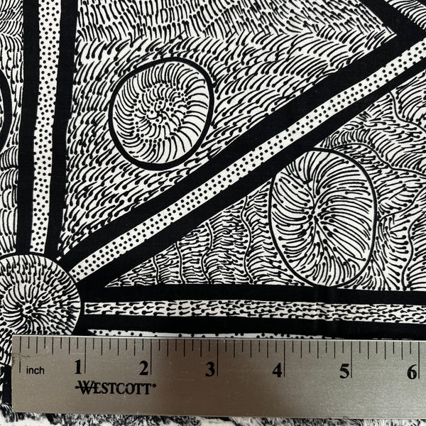 White and black fabric with abstract design, detail picture with ruler for sca;e