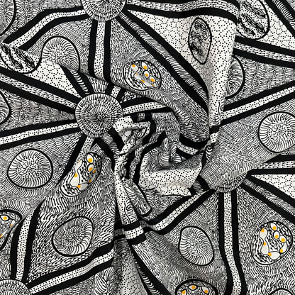white, black and a tiny bit of yellow abstract design fabric, shown in a decorative swirl