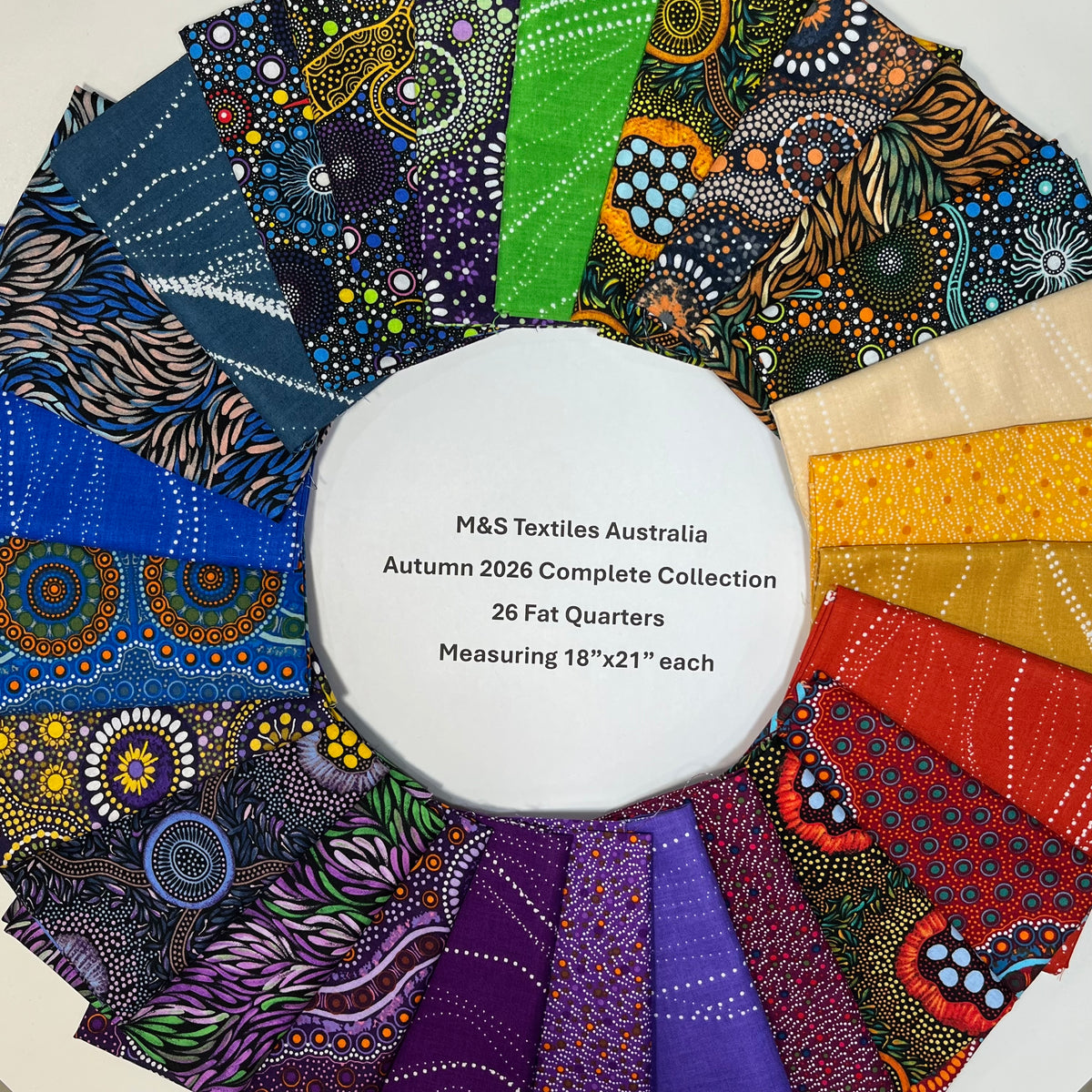 A circular white label reading 'M&S Textiles Australia Autumn 2026 Complete Collection 26 Fat Quarters Measuring 18"x21" each' sits in the center of a fan arrangement of colorful patterned fabric swatches on a light neutral background.