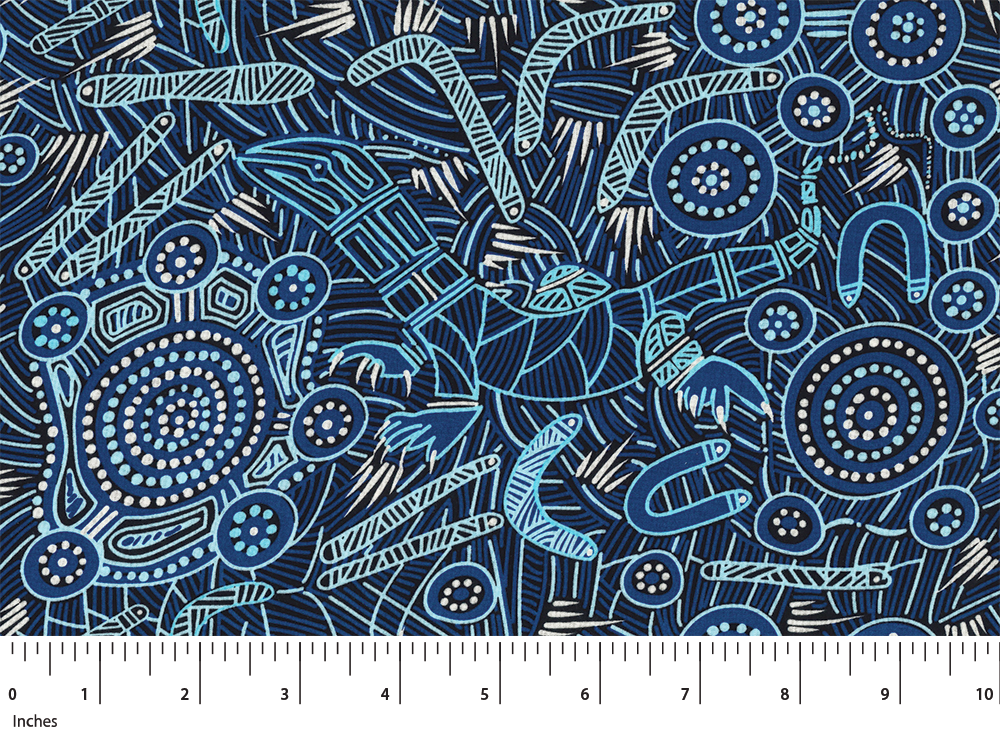 Patterned fabric with abstract designs on a blue background, featuring a ruler at the bottom for scale.