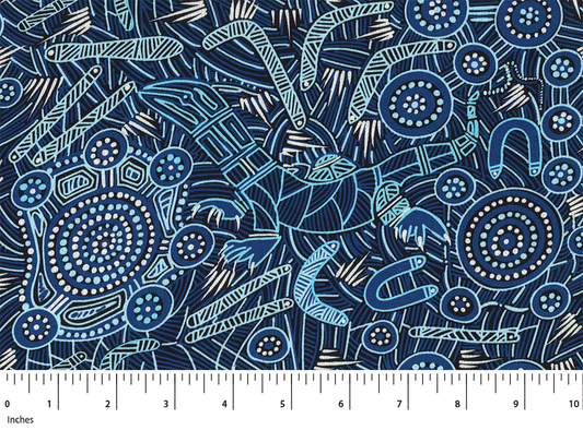 Patterned fabric with abstract designs on a blue background, featuring a ruler at the bottom for scale.