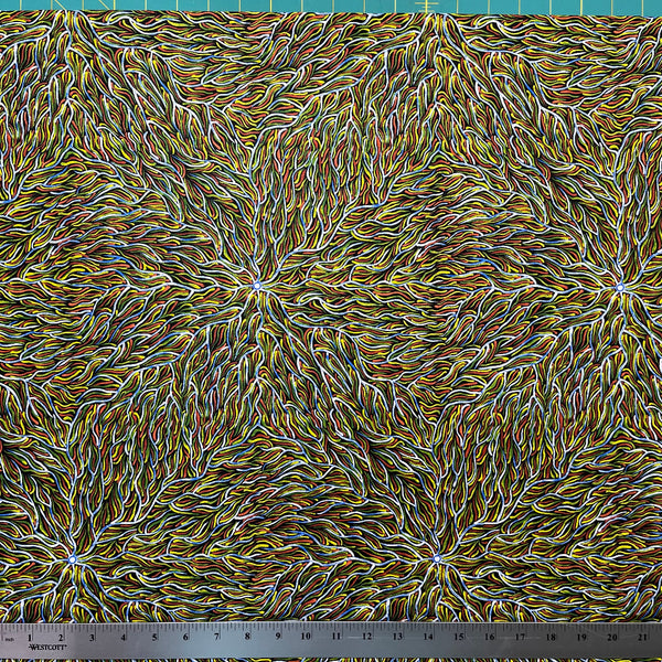 Running Water Dreaming Lemon is an intricate design of fine lines in bluish white, lemon yellow and red on a black background, simulating the rivulets of water splashing from a central waterhole. 