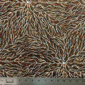 Running Water Dreaming&nbsp; brown is an intricate design of fine lines in white, brown, beige and black, simulating the rivulets of water splashing from a central waterhole.