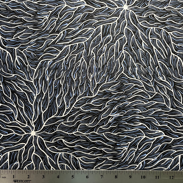 Running Water Dreaming grey is an intricate design of fine lines in white, grey and purplish grey on a black background, simulating the rivulets of water splashing from a central waterhole.