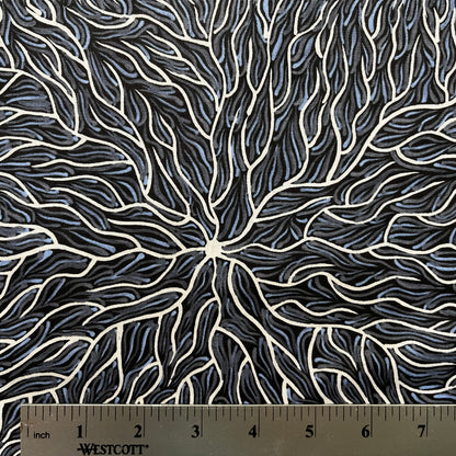 Running Water Dreaming grey is an intricate design of fine lines in white, grey and purplish grey on a black background, simulating the rivulets of water splashing from a central waterhole.