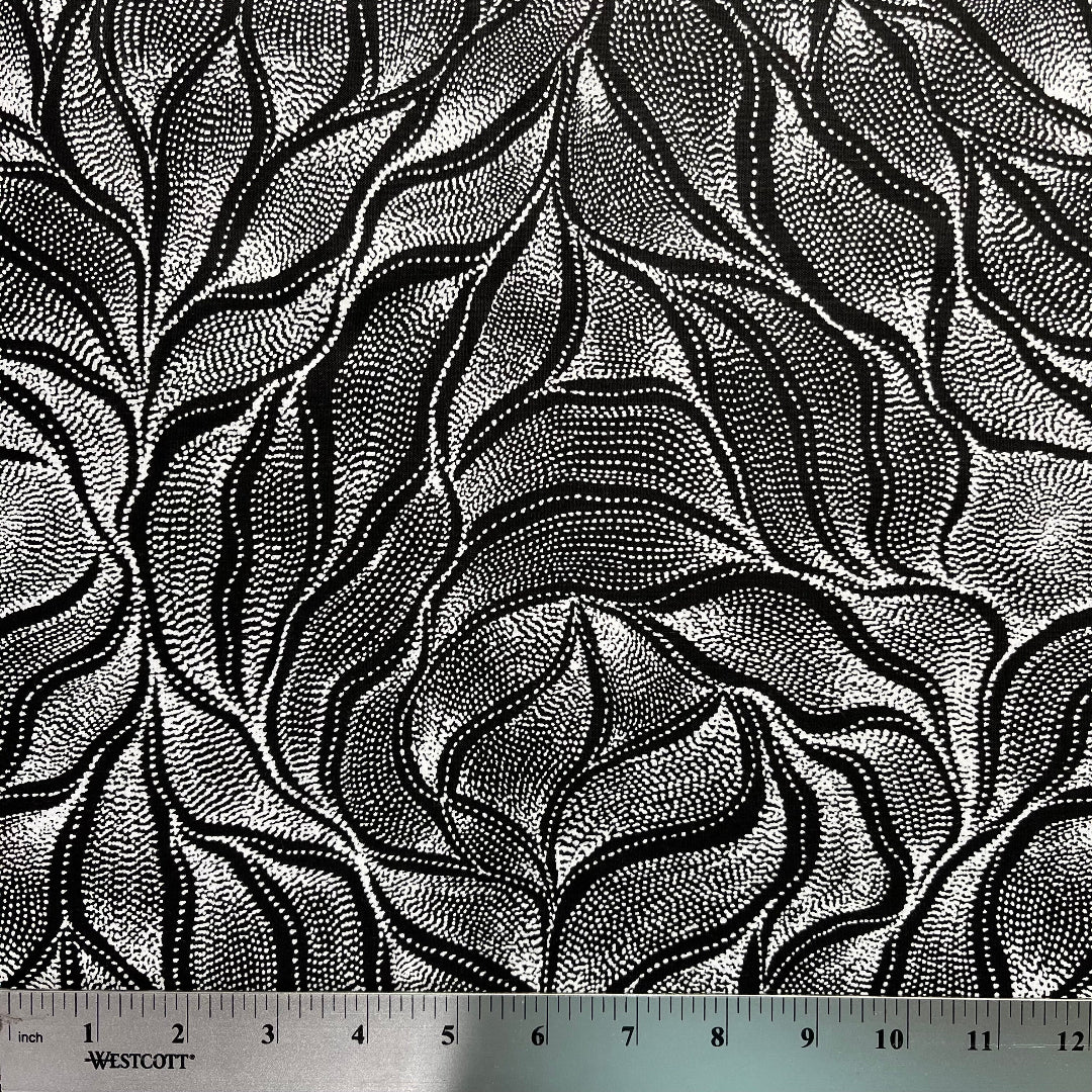 Sandhill and Waterhole Black&nbsp;is a striking design by Aboriginal artist Anna Pitjara, featuring intricate white motifs on a deep black background.