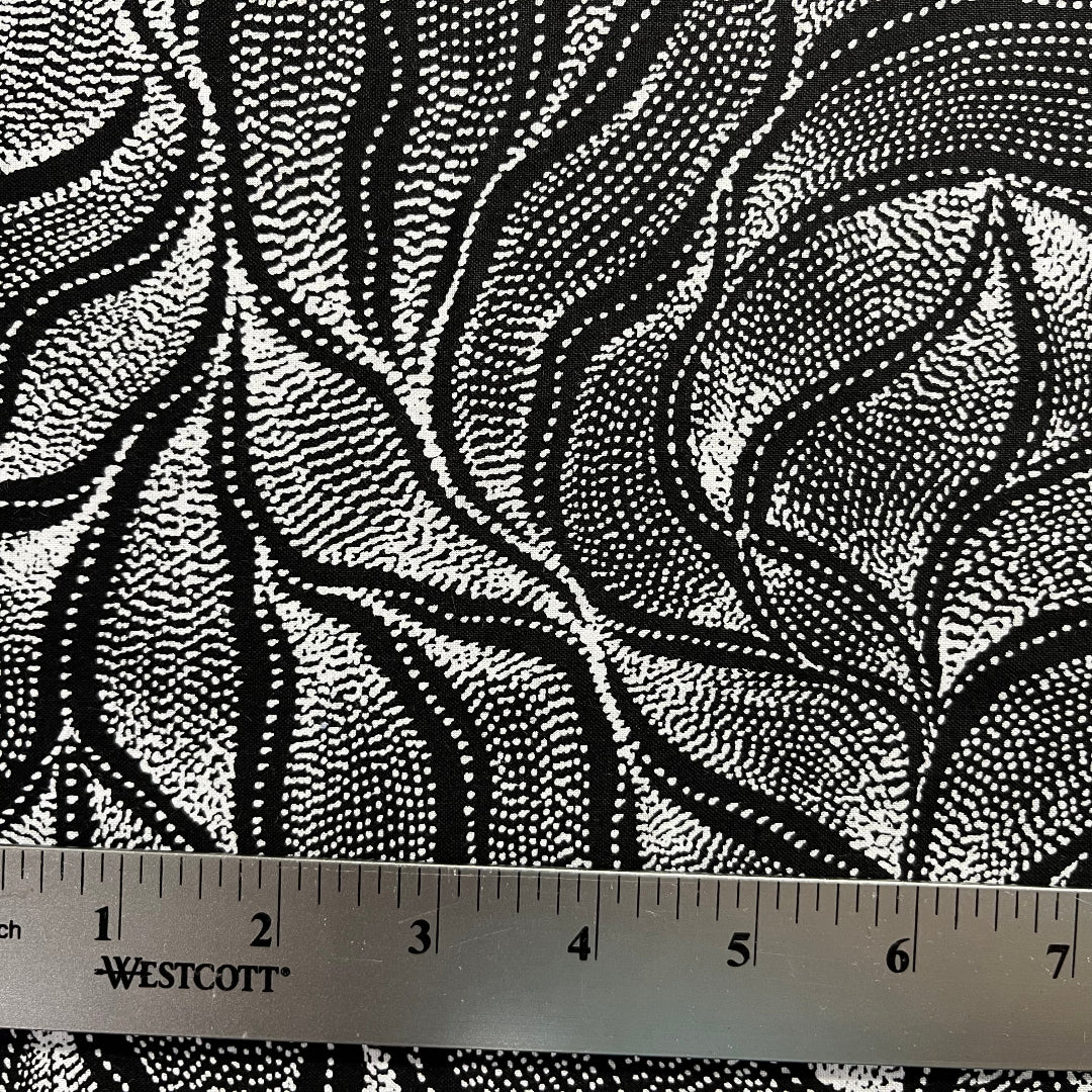 Sandhill and Waterhole Black&nbsp;is a striking design by Aboriginal artist Anna Pitjara, featuring intricate white motifs on a deep black background.