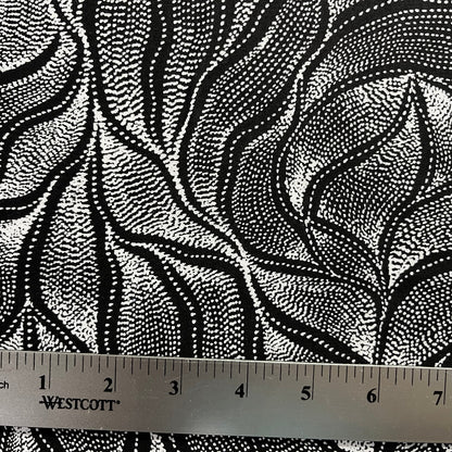 Sandhill and Waterhole Black&nbsp;is a striking design by Aboriginal artist Anna Pitjara, featuring intricate white motifs on a deep black background.