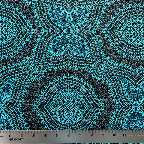 In this fabric, softly contrasting shades of sky blue, turquoise, black and white accents form patterns representing wind-scattered seeds and spinifex grasses—elements deeply rooted in desert life and culture.