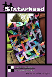  Sisterhood quilt pattern is a modern design using Fat Quarters and a solid black background, creating colorful grids.