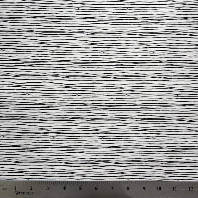 A very simple yet interesting design in black on a white background, looking like strands of string, designed by Kim Schafer.